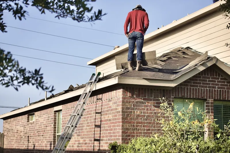 Professional roofer working on a residential roof in Pearl